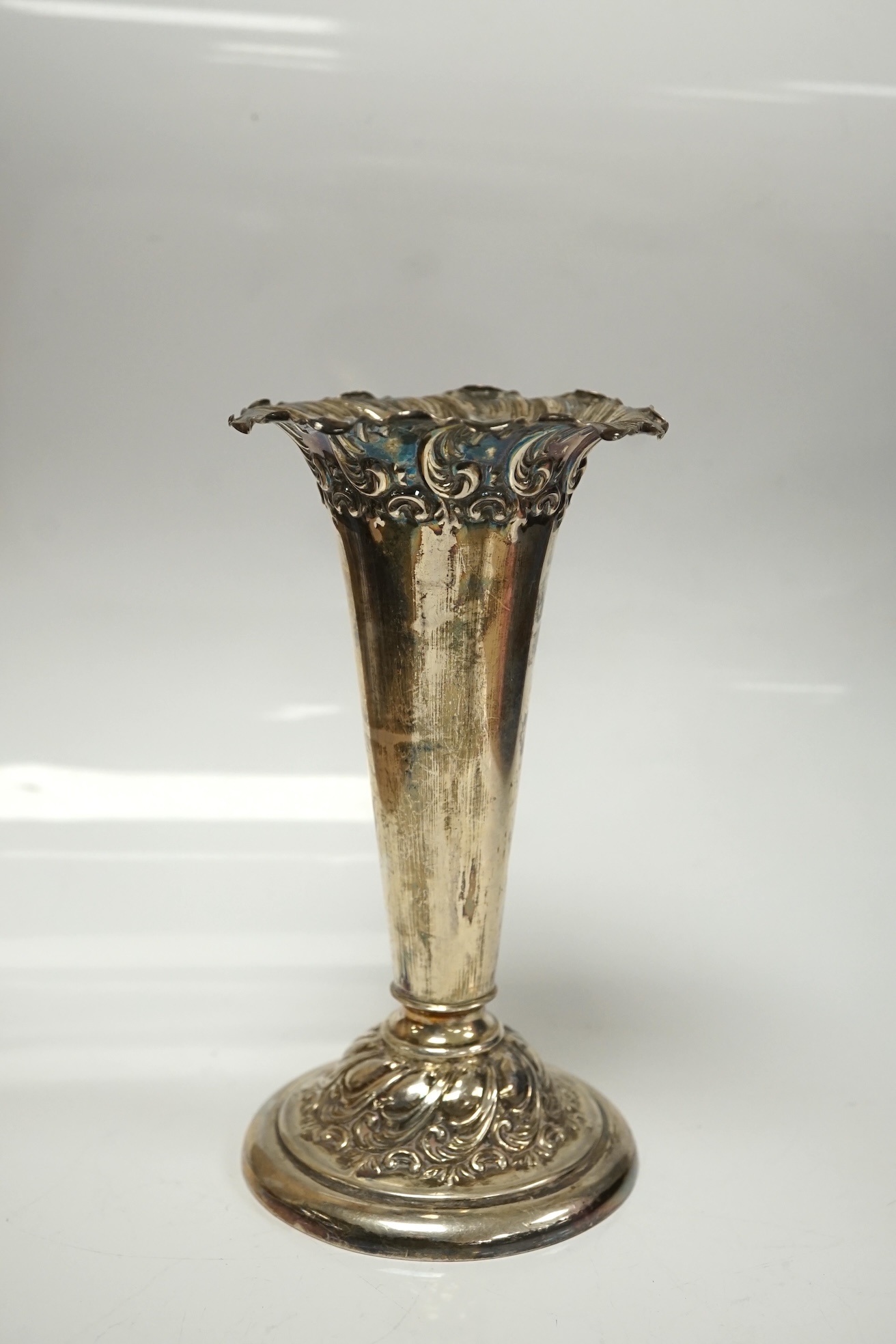 A late Victorian silver mounted horn beaker, Mappin & Webb, Sheffield, 1896, 10.6cm, a.f. a similar repousse silver posy vase and two silver mustard pots. Condition - poor to fair